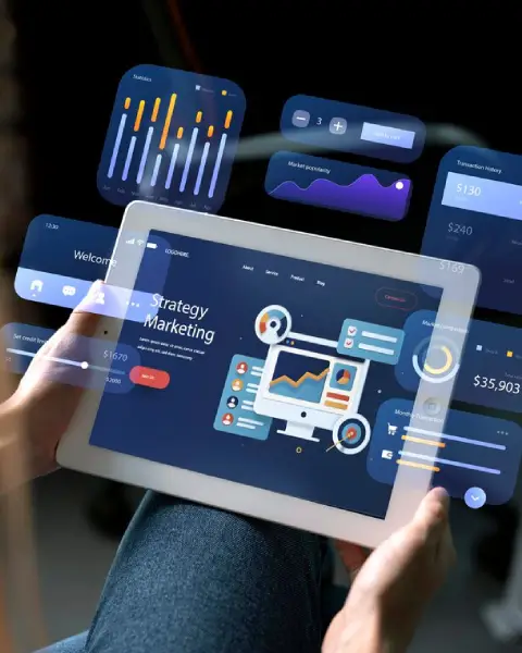Hands hold a tablet displaying a marketing strategy screen with multiple floating, holographic data visualizations